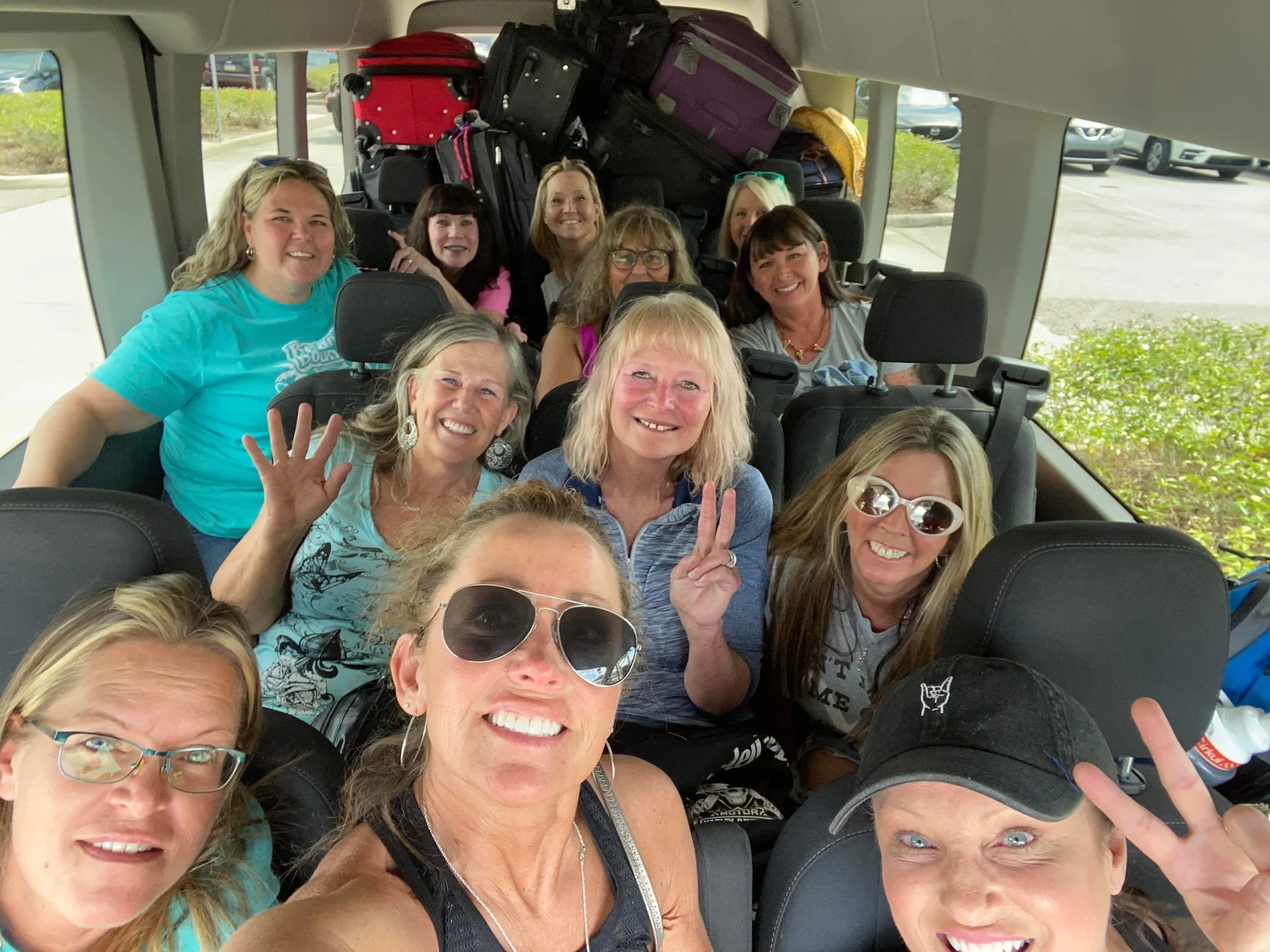 Group of happy passengers smiling inside a spacious passenger van